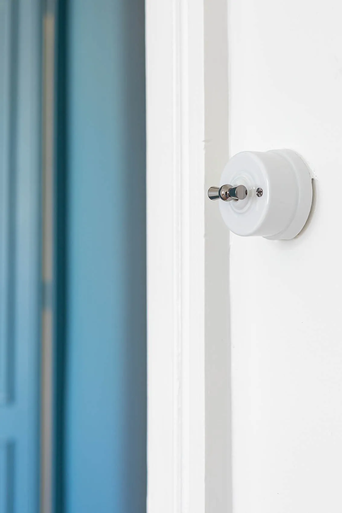 Interrupteur rétro rond blanc à manette métal, clin d’œil vintage de l’appartement des années 30